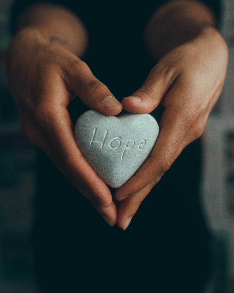 heart shaped stone with the word hope